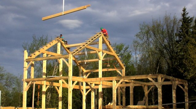 Timber frame home being raised