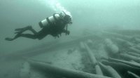 Diving to retrieve sunken timber from the log drive