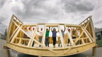 Habitat workers raise a wall at the the Red River Ex June 2011