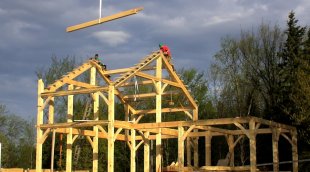 Timber frame home being raised