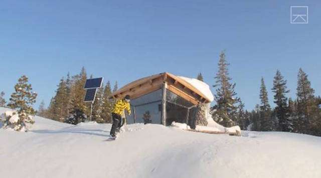 Mike Basich snowboarding outside his tiny but awesome off-grid cabin