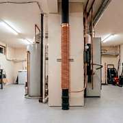 A  copper drain water heat recovery unit in a residential plumbing stack.