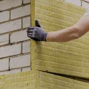 Worker Installing EIFS Exterior Rigid Insulation Panels