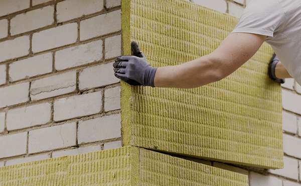 Worker Installing EIFS Exterior Rigid Insulation Panels