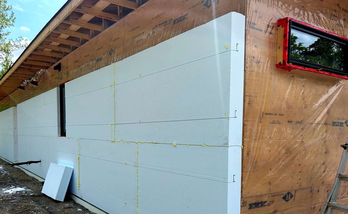 adding seamless rigid foam insulation to the exterior of a home