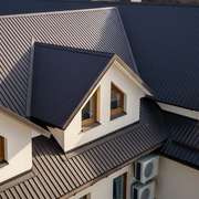 A complicated roof with dormers and metal roof covering