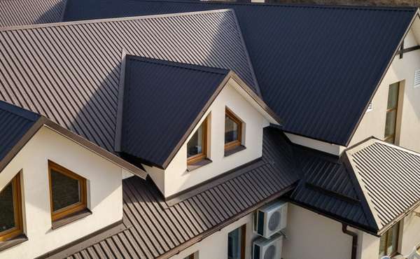 A complicated roof with dormers and metal roof covering