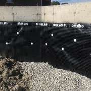 Basement foundation with exterior dimple membrane for water protection