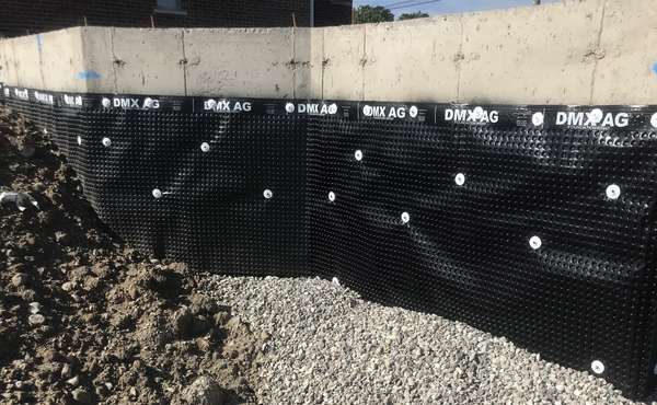 Basement foundation with exterior dimple membrane for water protection