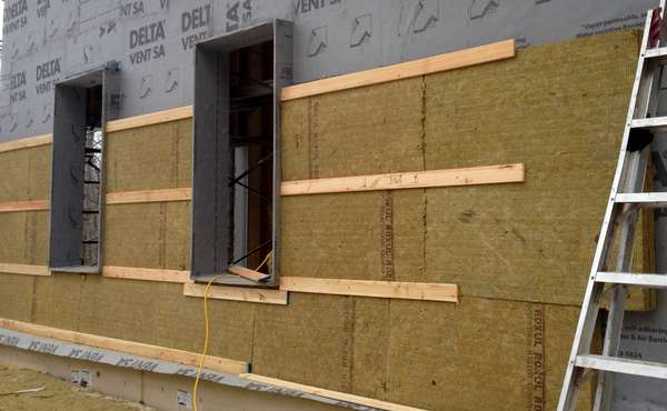 Rigid Rockwool mineral wool insulation boards being installed. Image © Ecohome