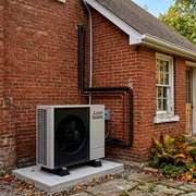 Heat Pump Compressor on a Brick Home in Vancouver