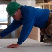 Installing recycled drywall in the Edelweiss House