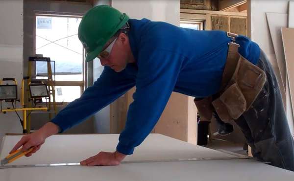 Installing recycled drywall in the Edelweiss House