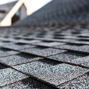 A close-up macro shot of the ceramic granules on a new asphalt roof shingle.
