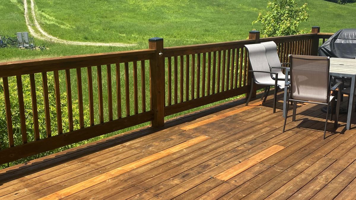 Terraza de madera de cedro recién teñida después de renovar la antigua terraza p