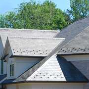 A beautiful, overlapping pattern of a natural slate tile roof on a home.