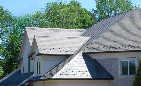 A beautiful, overlapping pattern of a natural slate tile roof on a home.