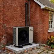 Heat Pump Compressor on a Brick Home in Vancouver