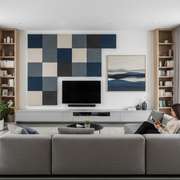 An interior photo of a living room with decorative fabric-wrapped acoustic panel