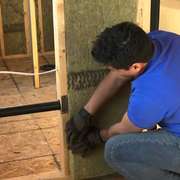 Installing soundproofing batts in interior partition walls of drywall