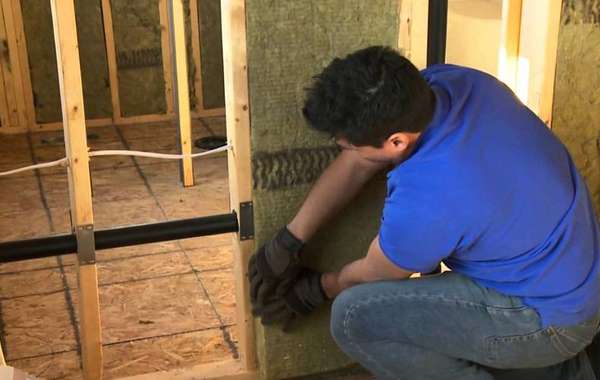 Installing soundproofing batts in interior partition walls of drywall