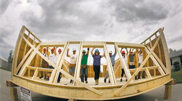 Habitat workers raise a wall at the the Red River Ex June 2011