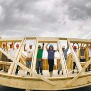 Habitat workers raise a wall at the the Red River Ex June 2011