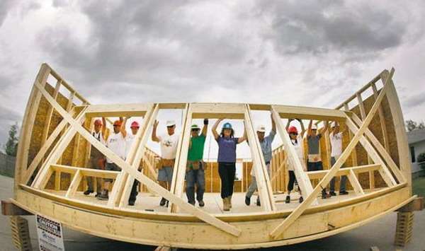 Habitat workers raise a wall at the the Red River Ex June 2011
