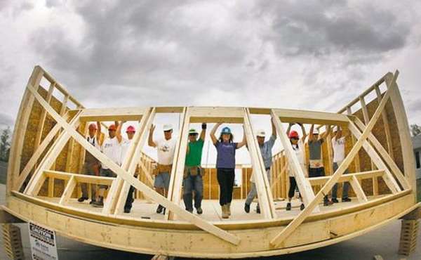 Habitat workers raise a wall at the the Red River Ex June 2011