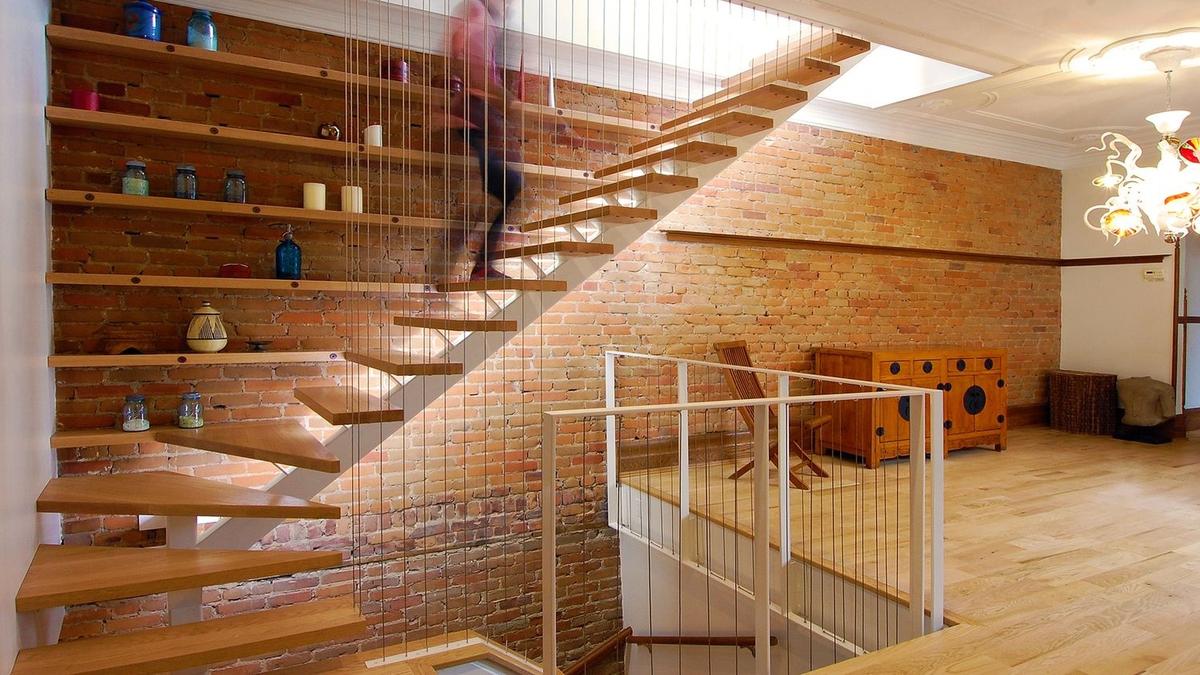 A modern, minimalist staircase with wood treads Image © Studio MMA Architects