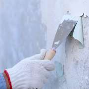 Lead paint peeling off a wall being scraped