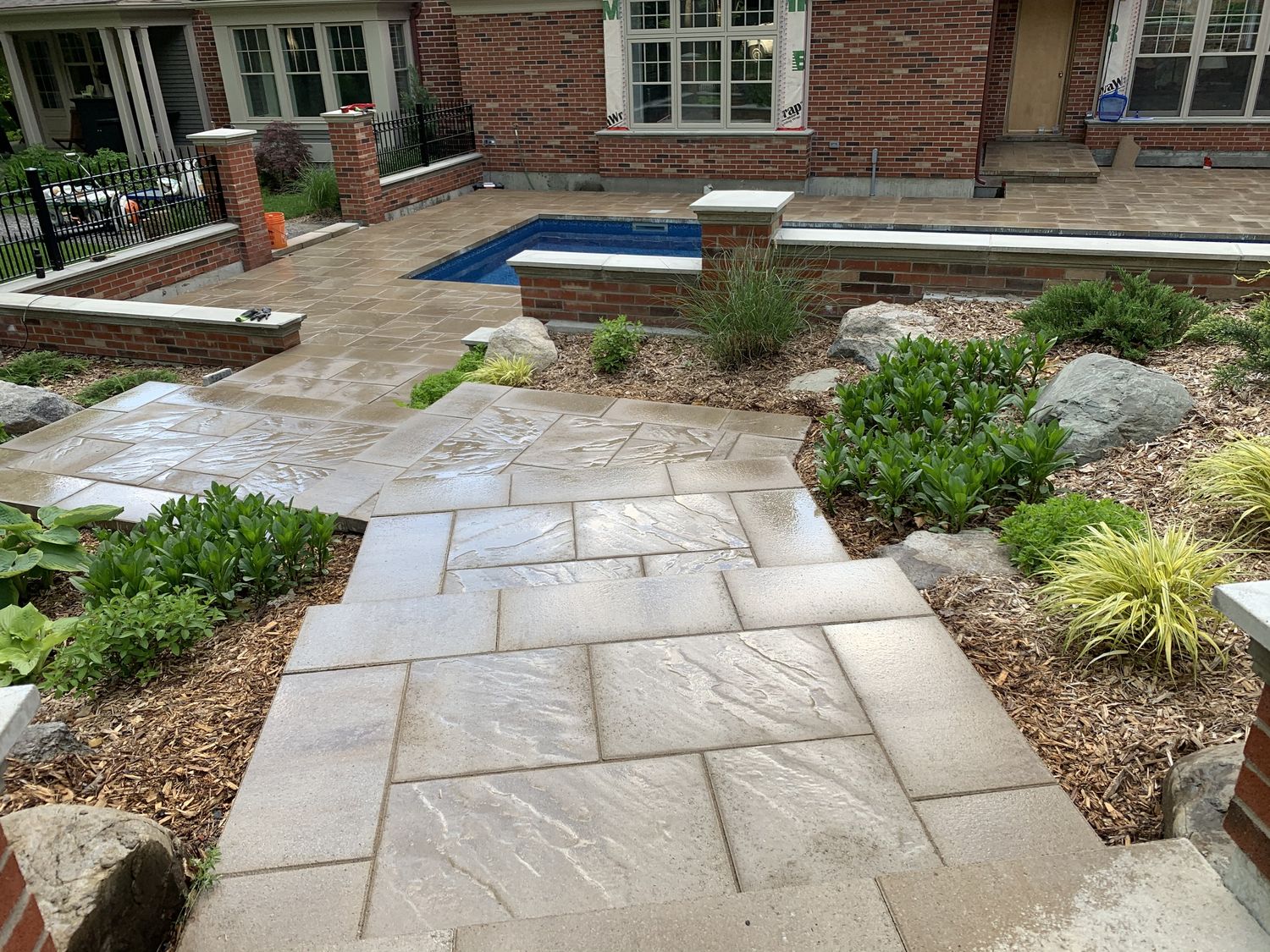 Backyard from a Decorative stone walls project near Granby - Bromont - Cowansville by Les Créations Pierre Langlois