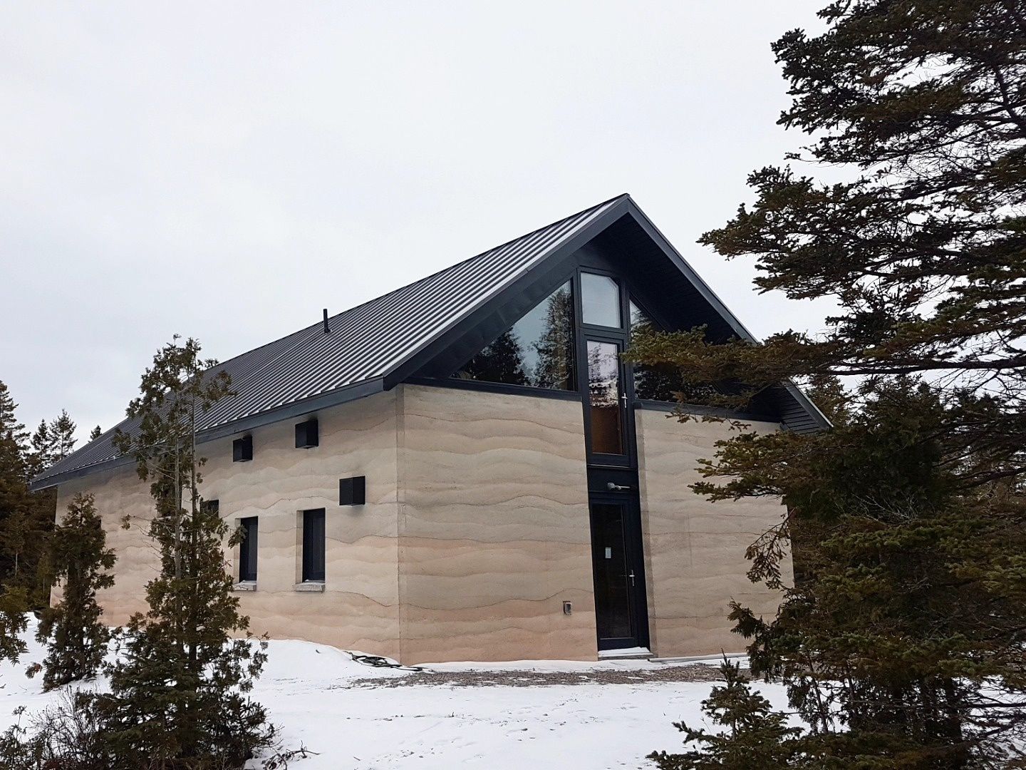 House Exterior from a Clay walls (Rammed Earth) project near Barrie by Aerecura Sustainable Builders