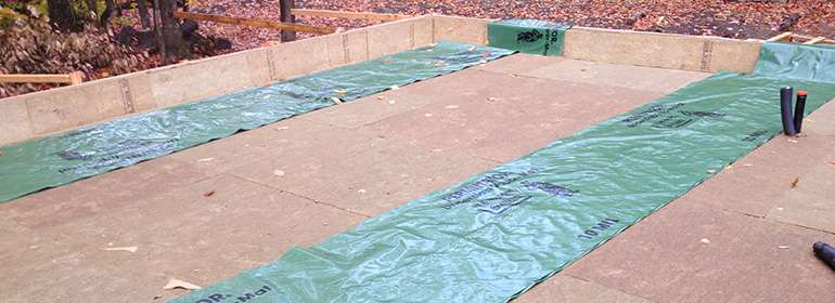 insulated slab-on-grade foundation forms waiting for vapour barrier installation