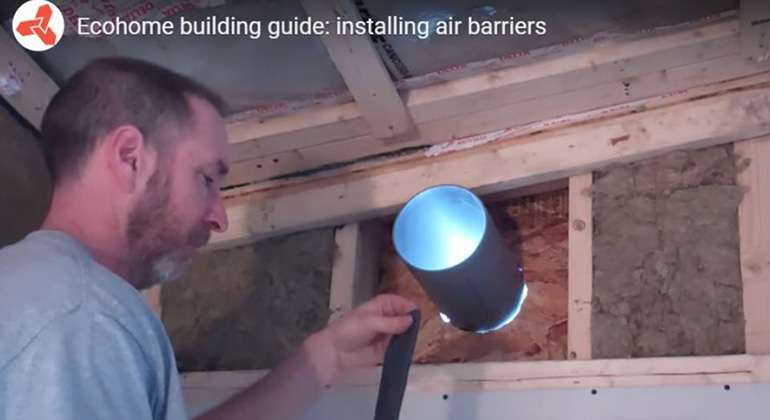 An air barrier being carefully taped and sealed around a ventilation opening.