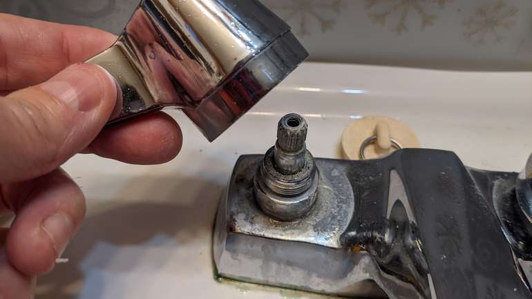 How to unscrew a faucet cartridge with plumbers grips to repair a drip