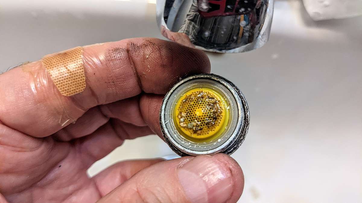 While you have your plumbers grips to hand, unscrew the faucet outlet aerator and clean the sand, grit and unmentionables out!