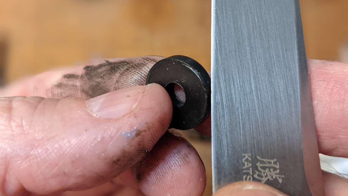If the new sealing washer has any excess rubber around the edge, trim it carefully with a sharp knife so it can seat well