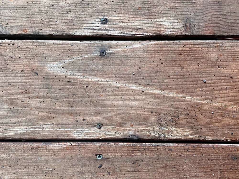 The mark of Zorro! Hold a pressure washer way from wood decks so it won't cause damage.