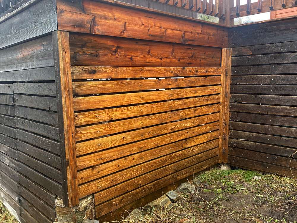 Old neglected cedar deck siding boards after cleaning off carefully with a pressure washer to restore the color 