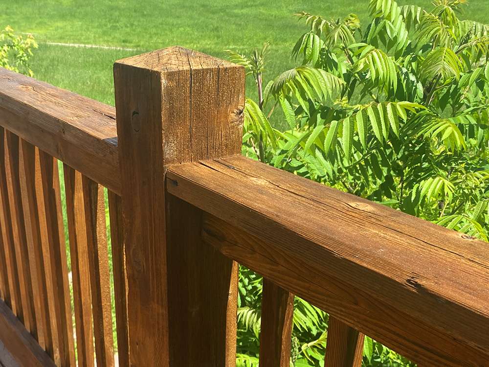 Staining a cedar deck to look like new - After photo of the newly stained deck railing