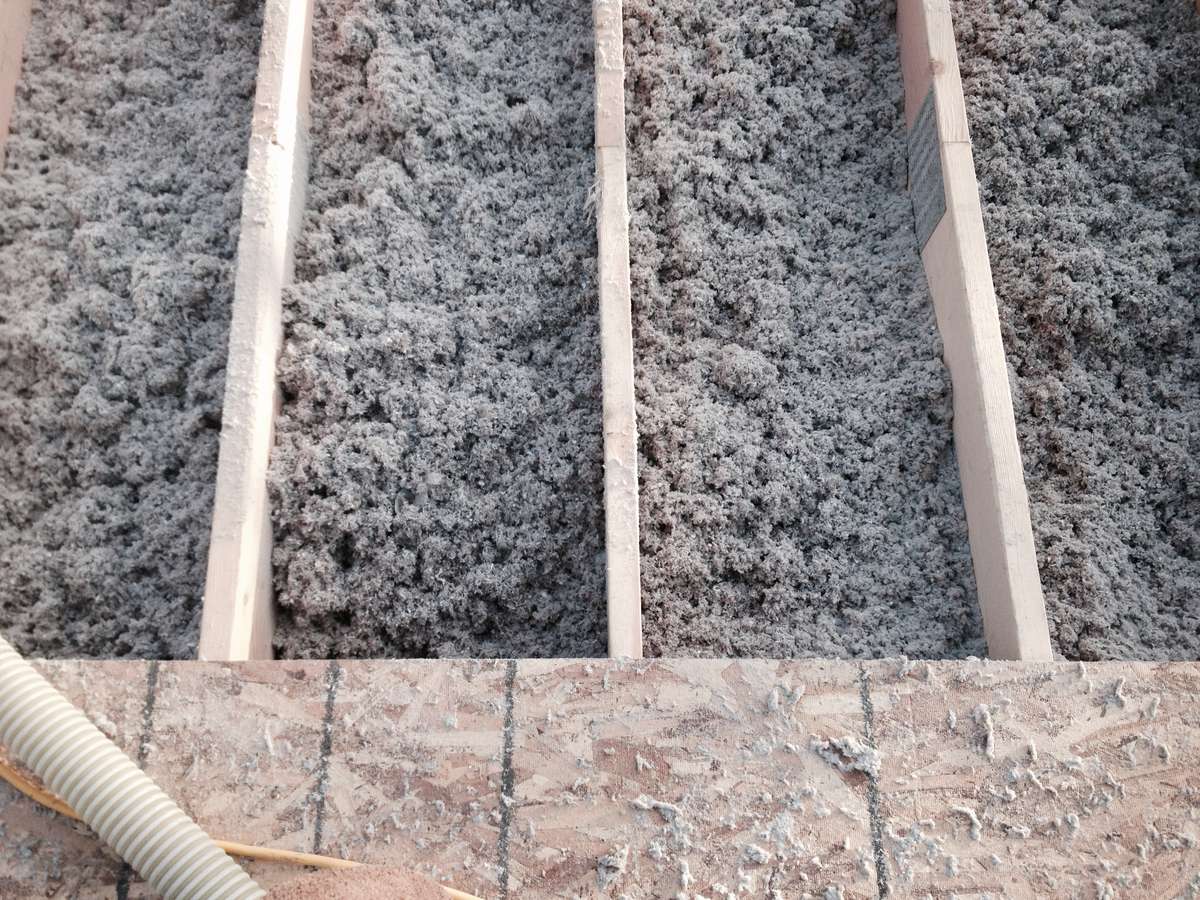 Loose fill cellulose insulation in a roof has a reduced embodied carbon rating
