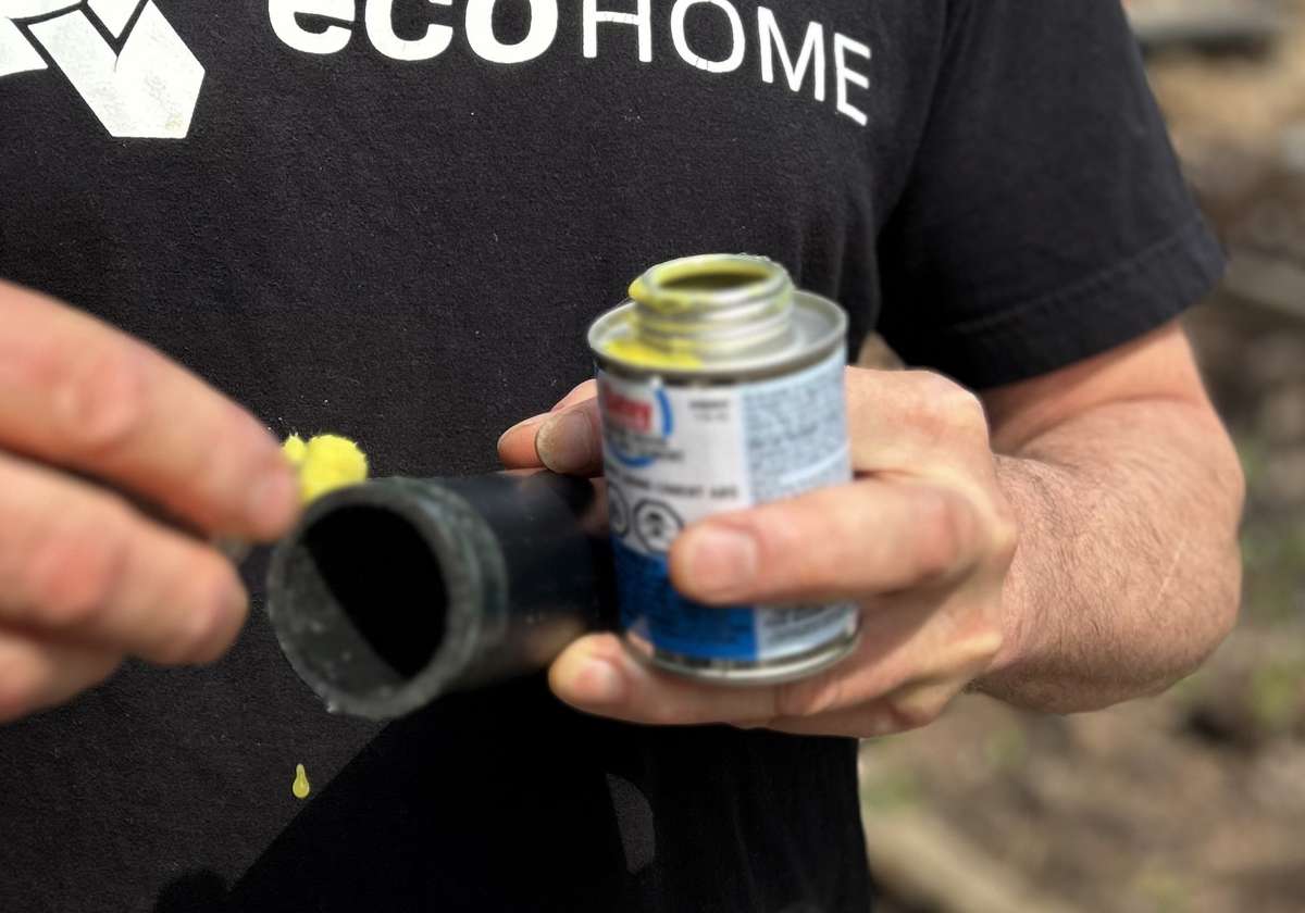 Put ABS glue on a drain pipe to attached an elbow or union joints.. - Image © Mike Reynolds