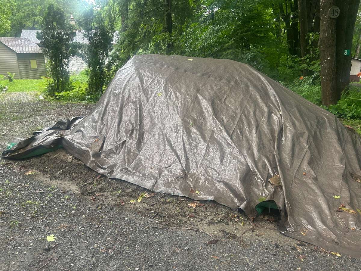 top soil from foundation excavation saved and covered with a tarp to be used for landscaping