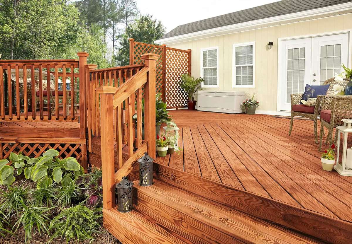 Pressure-treated wood decking planks showing their green or brown tint from the treatment.