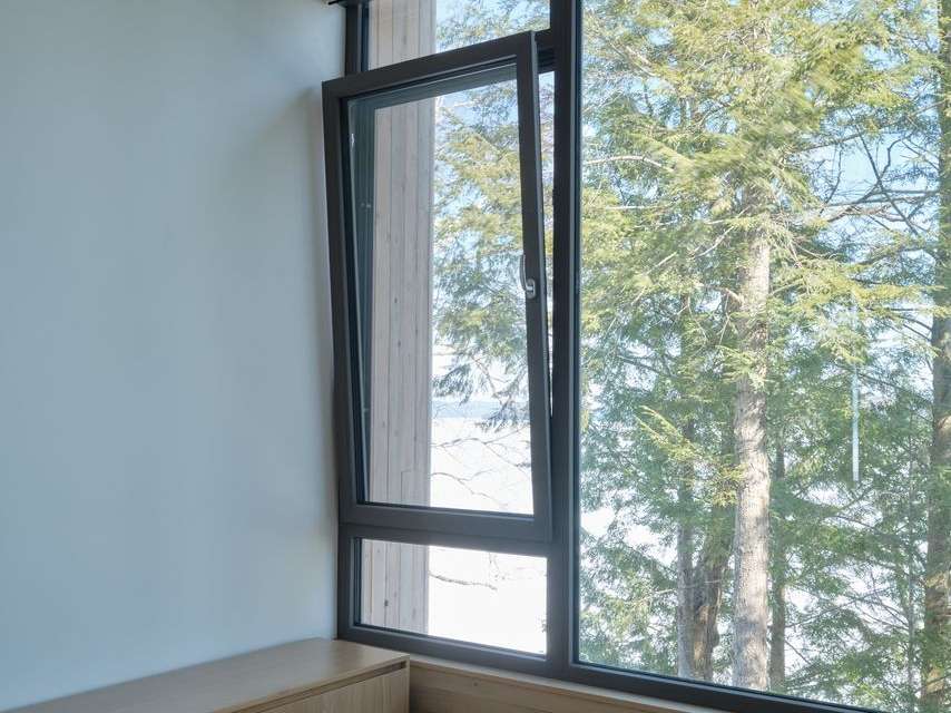 Tilt and turn window in a modern home open in variable positions to offer options for ventilation