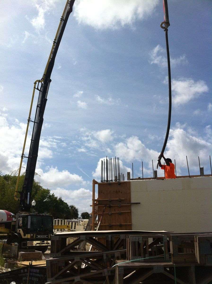 A concrete pump pouring concrete into an ICF wall.
