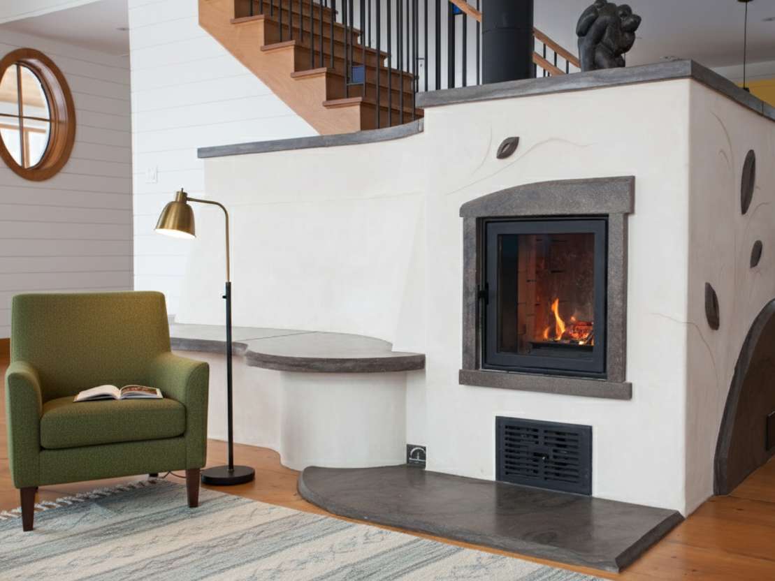A masonry wood burning stove with heated bench
