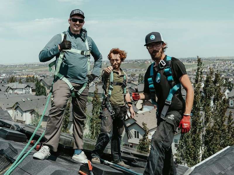 workers installing solar panels on a roof in Alberta